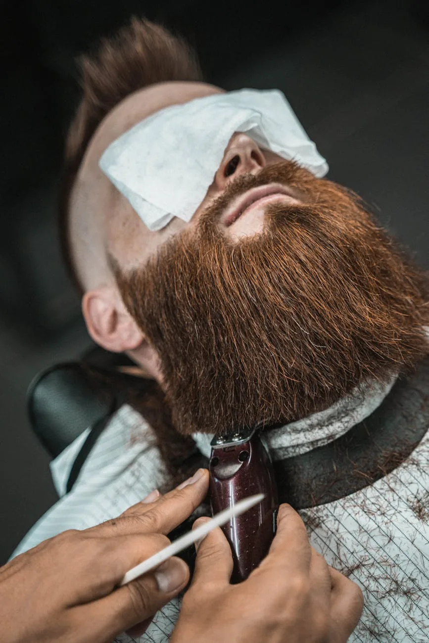 photo of a man getting his beard shaved