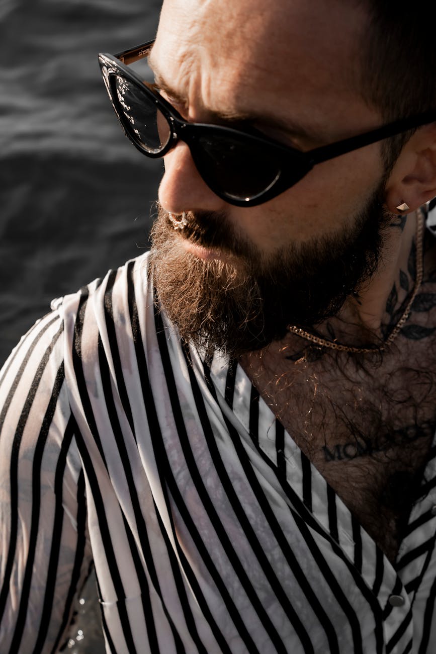 a man with a beard and sunglasses in the water