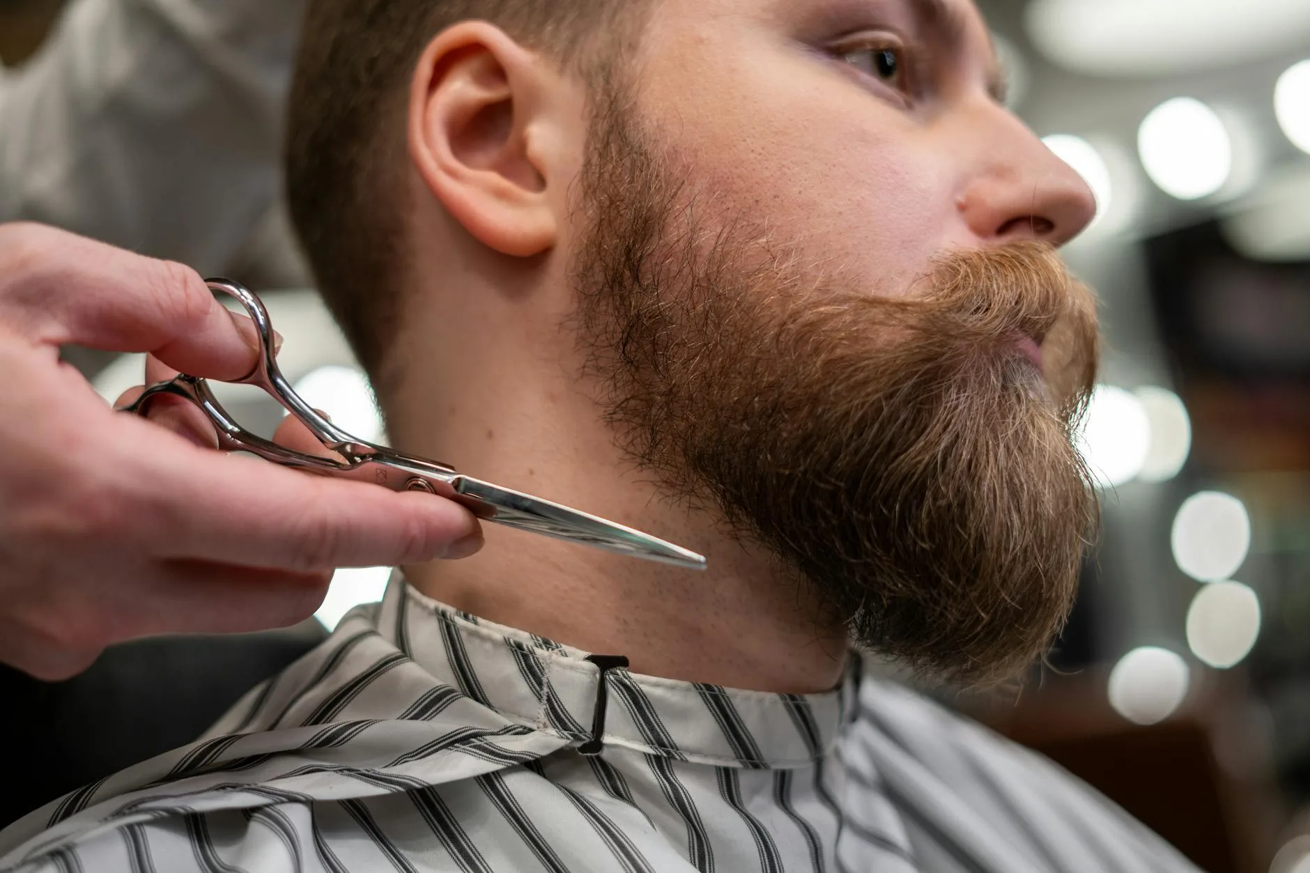 man getting a beard cut