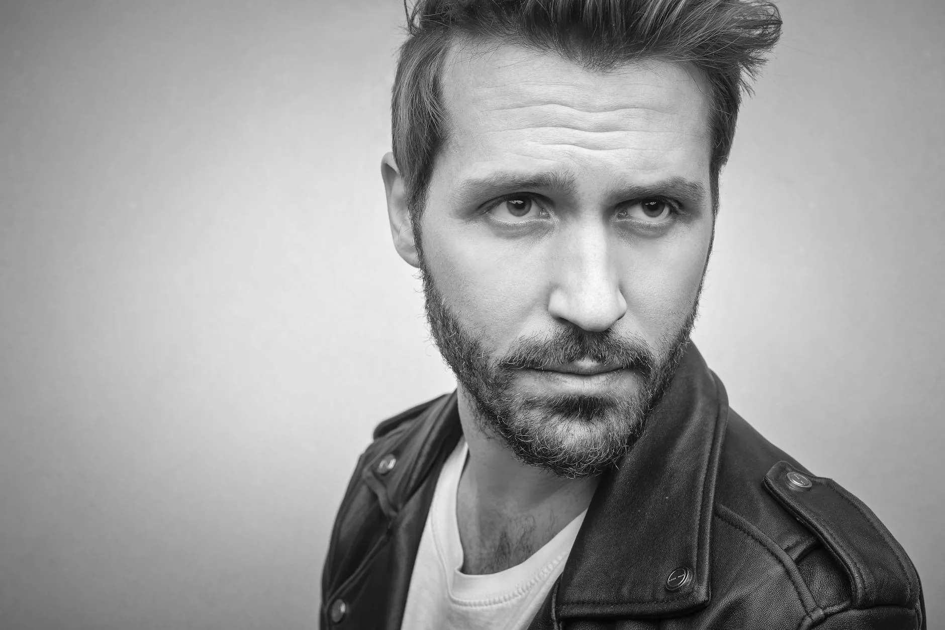 bearded man wearing black leather jacket