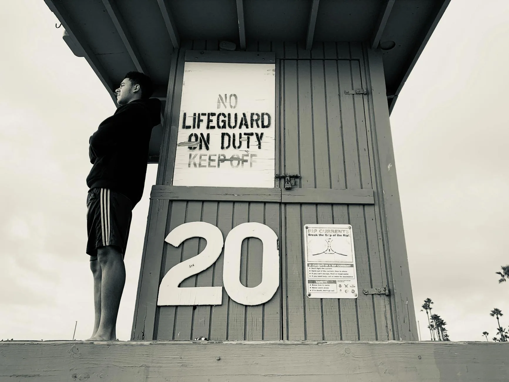 man standing on the life guard house