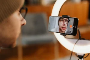 man filming video on smartphone